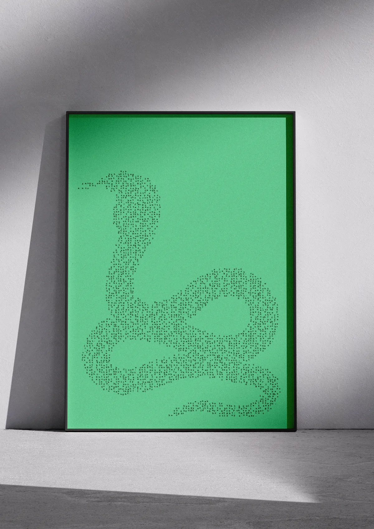 Typographic poster "Slither", black on green, framed on a wall. A coiled snake.